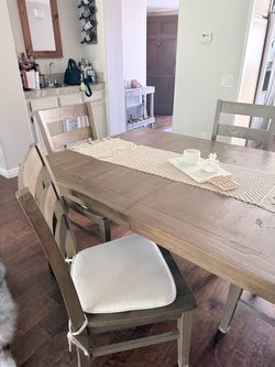 Rustic wood dining table with 4 chairs. Comes with leaf insert.