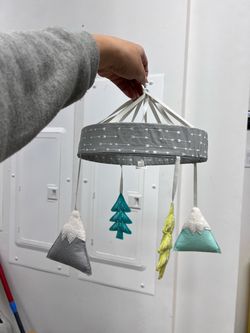 Crib mobile with attachment to crib