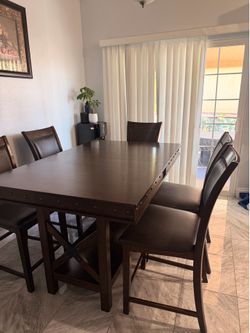 Dark wood dining table with 6 chairs