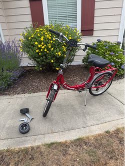 Red Schwinn loop folding bike + training wheels