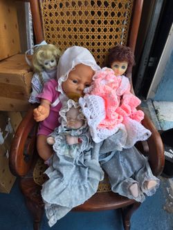Dolls in chair