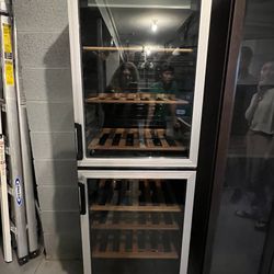 Wine Refrigerator by Vinotemp 2 doors top and bottom. Holds 100 bottles