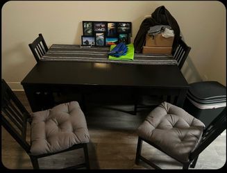 Black expandable table with four chairs