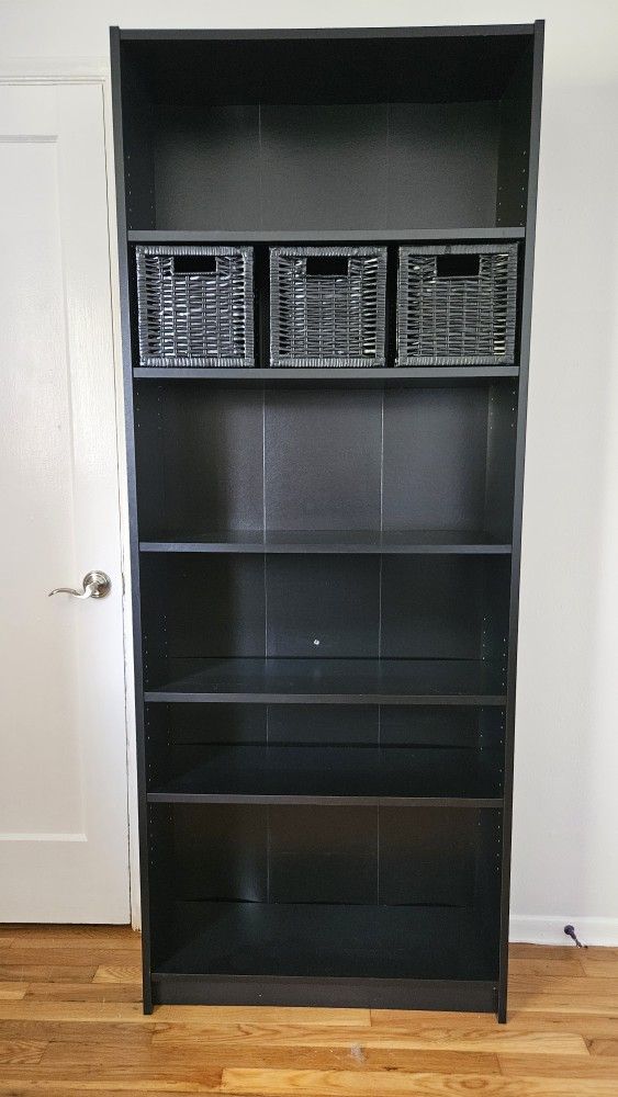 Tall Black Wooden IKEA BILLY Bookcase
79.5"H x 31.5"W x 11"D
5 adjustable shelves
3 black wicker storage baskets (9"H x 9"W x 10"D)