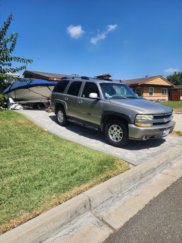 2002 Chevy, Tahoe, 4 wheel drive and boat and trailer.
