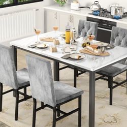 A dining table and four chairs