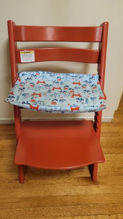 Red Stokke Tripp Trapp chair with custom seat cushion
