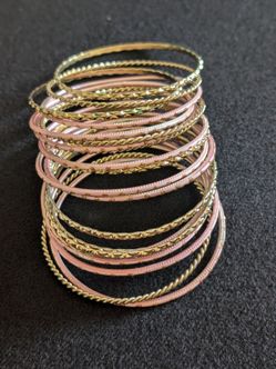 21 gold tone and blush pink bangles 2.75" round