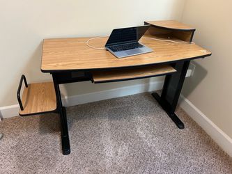 Computer desk in good condition with a wood-look finish and sturdy black metal frame