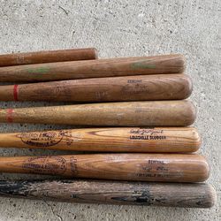 Vintage Wooden Baseball Bats including Louisville Sluggers. Vintage metal baseball bats and gloves from 1970's. Balls.