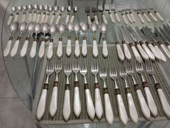 12 settings 8/10 stainless with pearlized handles. Very elegant. Excellent condition.