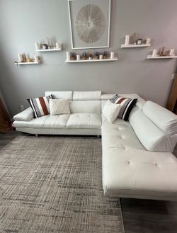 White sectional sofa with rug included (pillows not included)