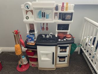 Kids kitchen with food and cleaning toys