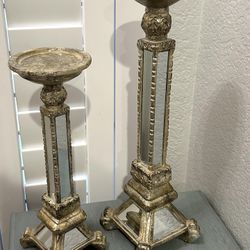$5 - Set of 2 Elements mirror and gold Pilar candle holder.  Small is 12” and the large one is 15.5”.  Please pickup in the area of 36th Ave and Pinna
