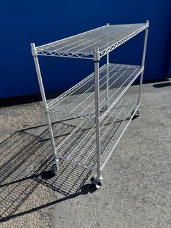 Heavy-duty 3-tier wire shelving unit on caster wheels.