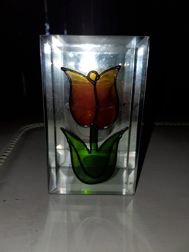 Painted glass tulip with a candle holder in between a mirror back