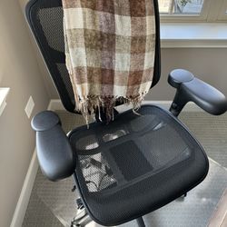 Black office chair + plastic rolling mat