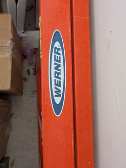 Werner 12-foot fiberglass step ladder with a 16-foot reach height
