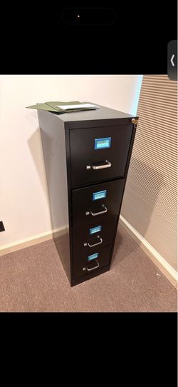 Four-drawer filing cabinet with labels and handles.