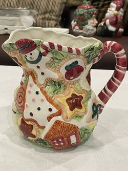 Ceramic Christmas cookie pitcher with a candy cane handle by World Bazaars.