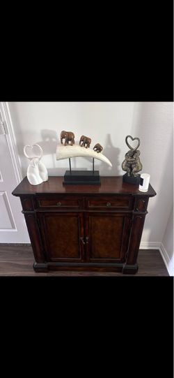 Dark wood entry cabinet L-40” W12” H 35”.