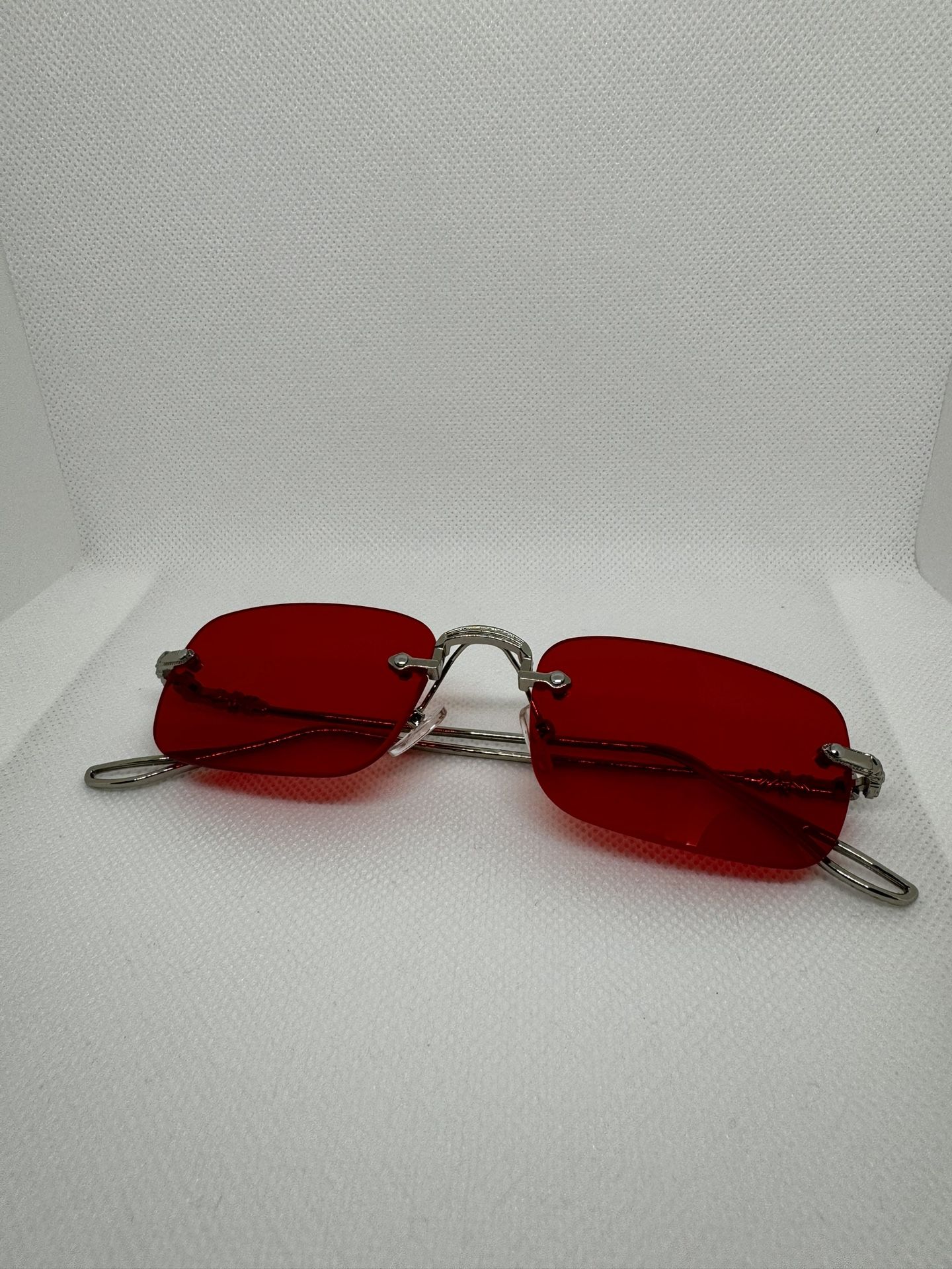 Metal rimless sunglasses with thickened lenses, a small metal frame stand, and metal hinges designed for street snap.