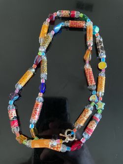 Vintage handcrafted artisan piece made with an assortment of textured and patterned cylindrical fabric or paper-wrapped beads, colorful glass/crystal