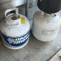 Two “Empty” blue rhino and black no name propane tank bbq grill Asador fire pit patio heater