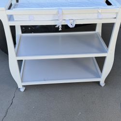 White Delta Children Changing Table with Wheels & Changing Pad