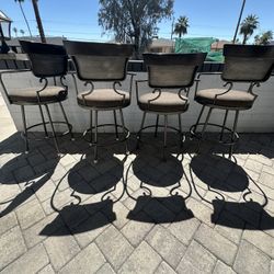 4 swiveling barstool chairs