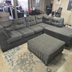 Ashley gray 2-piece sectional with matching ottoman 