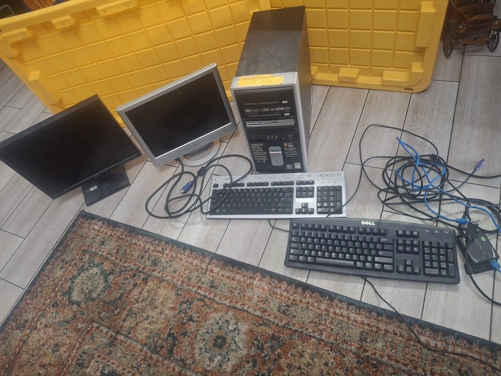 COMPUTER, MONITORS AND KEYBOARDS. EVERYTHING IN THE PICTURE FOR $50 WORKS
