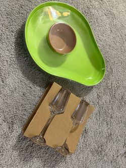 Wine glasses and avocado-chips platter