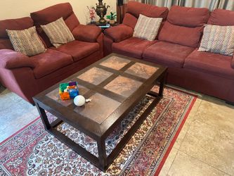 A Sofa and Love seat set with a Coffee table.