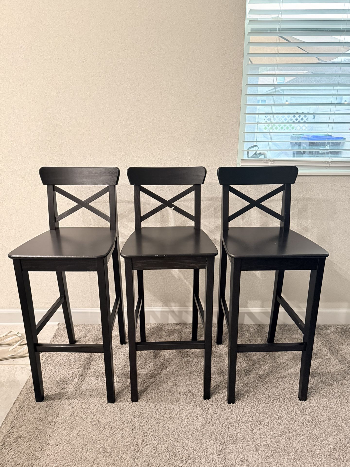 Selling 3 black wooden stools.