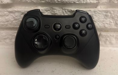 Wireless Game Controller Working perfectly Black wireless game controller with ergonomic design.