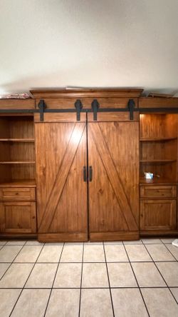 High end rustic wood entertainment center with sliding barn doors