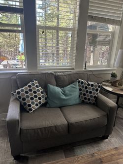Like New Ashley Brand Gray Sofa And Loveseat And Table
