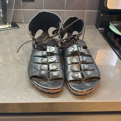 like Vivienne Westwood leather gladiator-style sandals with an ankle cuff and lace-up front.