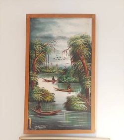 vintage landscape painting created in the Haitian Naive. With signature