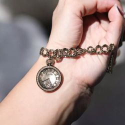 The Sears Roebuck Company, a charm bracelet with three charms, made by Roget,...