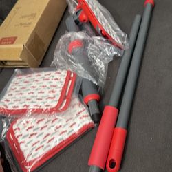 New flat mop. Has a red and black handle. Comes with two microfiber mop pads. Great for cleaning all floor types.