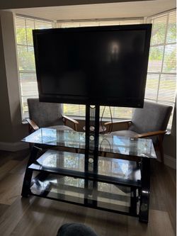Glass TV stand with mounted TV included