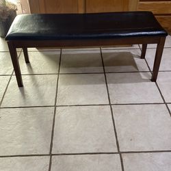 Wooden bench with black cushion top. Read description for detail details and location.