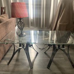 2 glass end tables, a lamp and a sofa Glass table