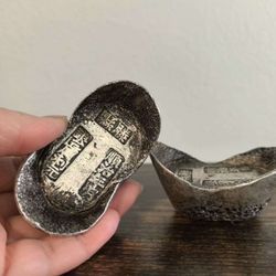 Ancient coins, ancient ten-tael silver ingots, and silver dollars.  