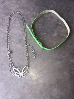 2 NEW kid’s adjustable Justice belts. One lime green leather and one silver chain w/a rhinestone butterfly