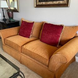 Elegant Golden-Hued Sofa with Velvet Accent Pillows