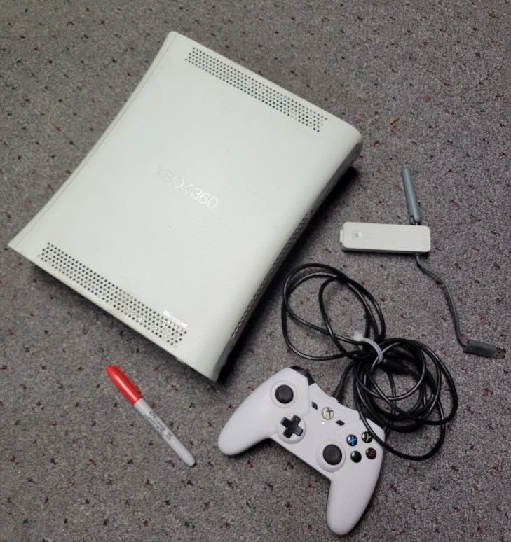 Xbox 360 +  the Wireless Adapter, A Second Unit, Controller And Power Cords Too.