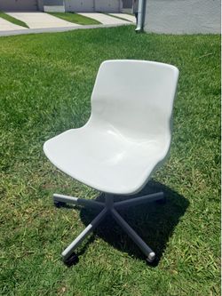 Selling a white kids’ chair with wheels.